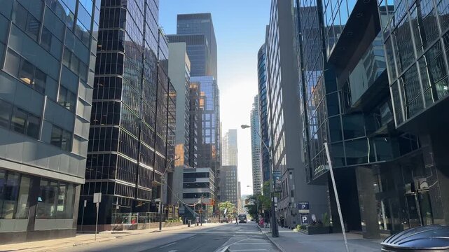 Ground Level Shot Showing Toronto Ontario Canada Streets With Cars Pedestrians And Modern Buildings Creating A Vibrant Urban Scene In The Heart Of The Canadian Metropolis On A Sunny Day