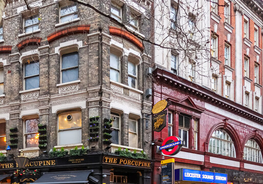 London, England, UK December 16, 2025: London street showcasing The Porcupine pub facade and Leicester Square Underground station