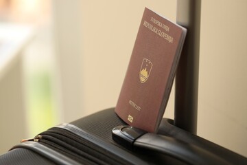 Slovenia passport on touristic baggage luggage in airport close up. Travel and tourism in Europe concept