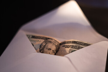 American dollars, banknotes in a white envelope.