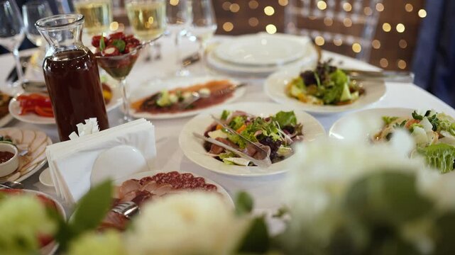 A wide variety of food and dishes on the bride and groom's festive table. A wedding banquet for the birthday and gala evening events.