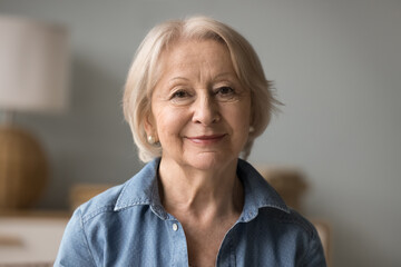 Gentle and elegant. Head shot portrait confident beautiful hoary elderly lady in stylish casual...