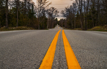 winding asphalt road with yellow lines