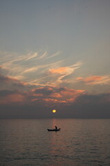 Fototapeta premium fishing boat at sunset