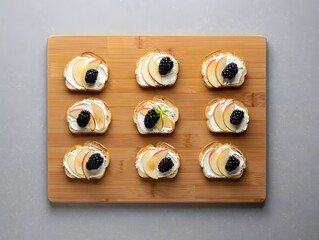 Nine fruit and cream cheese appetizers on a wooden cutting board