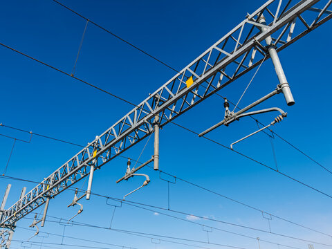 Railway overhead lines on blue sky, electrification system catenary