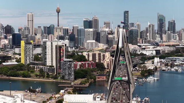 Vehicle traffic entering Anzac bridge to Sydney city CBD in aerial cityscape view.