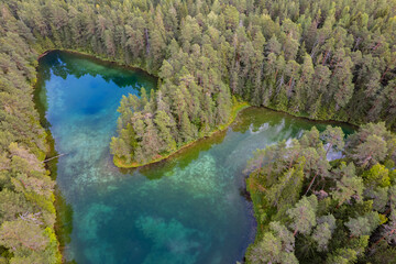 Emerald turquoise clear water lake in Estonia in an aerial drone view