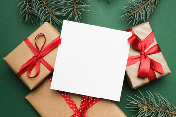 Merry Christmas square greeting card mockup surrounded by beautifully wrapped presents with red...