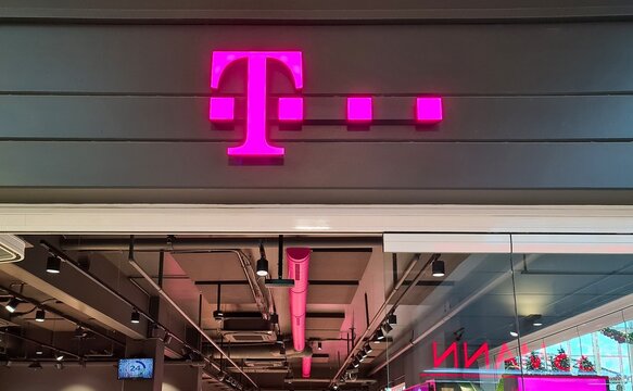 Flensburg, Germany - 20. December 2025: Deutsche Telekom T-Mobile brand logo sign in Flensburg