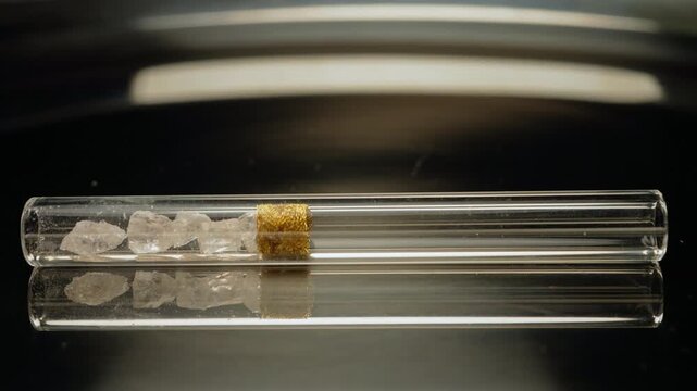 Crack cocaine drug in rocks or hard crystals with smoking crack pipe on the table. Illicit drugs very potent and addictive for sale in the streets and contribution to homelessness and addiction crises