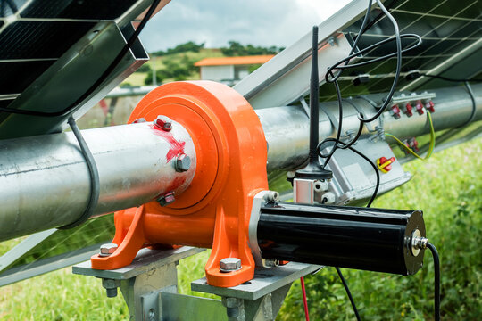 Rotor motor with antenna for automated drive gearing for single-axis horizontal solar tracking system.