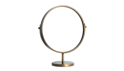 A minimalist, circular mirror in a golden frame with a stand, set against a black backdrop