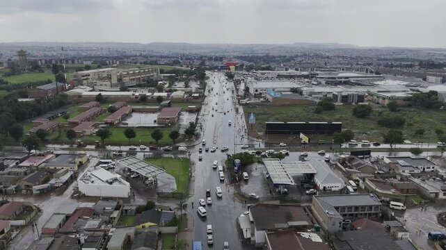 Drone flies east along Bolani Street over the firehouse just after a heavy rain in Soweto, South Africa