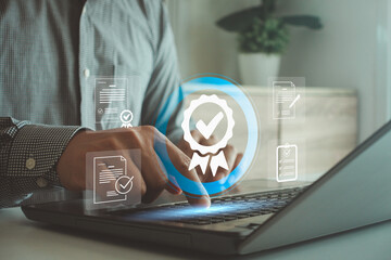 Business professional using laptop computer to verify and approve digital data with a glowing checkmark icon representing quality assurance and successful completion of tasks