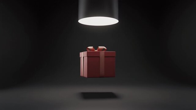 A red gift box with a ribbon floating under a spotlight in a dark, minimalist room, casting a shadow below.