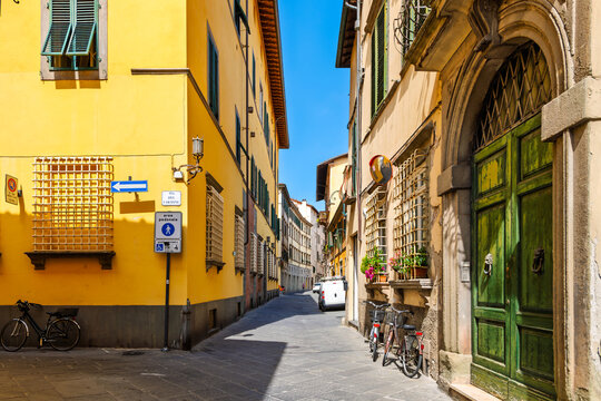 Fototapeta One of the colorful narrow streets in the medieval old town of Lucca, Italy, a city and comune in Tuscany, Central Italy.