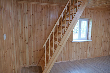 A new wooden staircase leading to the second floor of the house
