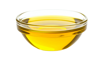 A clear glass bowl containing golden, viscous liquid on a dark, transparent background