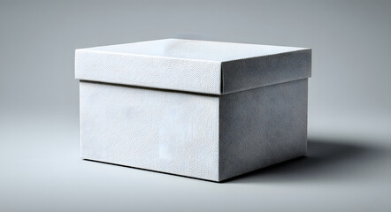 Naklejka premium A white cardboard box on a light grey background. The simple, clean design and neutral colors make it versatile for various uses and presentations