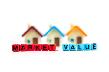 Concept of house or property market value created with home toys and letter beads on white background.