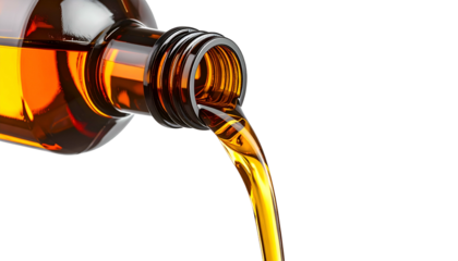 Amber liquid pours smoothly from a brown glass bottle against a stark black backdrop