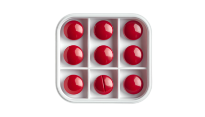 Nine red pills in a white pill organizer on a black background. One pill is cut