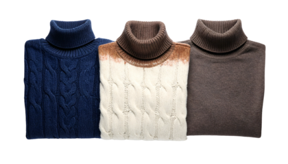 Three folded, turtleneck sweaters of varying colors in a studio setting
