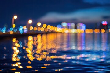 Blurred night cityscape with glowing lights reflected on water