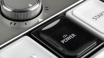 Close-up View of Power Button and Control Knob on Electronic Device in Modern Indoor Setting