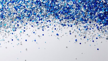 Scattered small blue and silver shiny particles against a white background