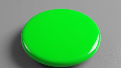 A single, bright green, glossy, round button isolated on a plain gray background, representing a simple choice or action.