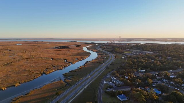 Aerial overview of the marsh, Turtle River, and the Sidney Lanier Bridge in Brunswick, GA
