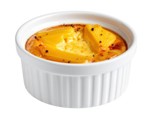 Breadfruit pudding in a white ramekin, caramelized and garnished with black peppercorns
