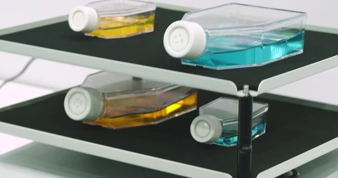 Glass vials ampoules liquid mixed on device in medical laboratory, medical analysis concept