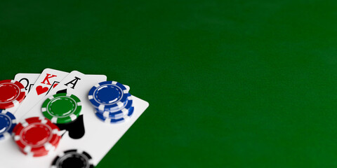 Concept Of Gambling, Risk, And Winning Strategy. Playing Cards And Colorful Casino Chips On Green Table With Copy Space. 3D Rendering