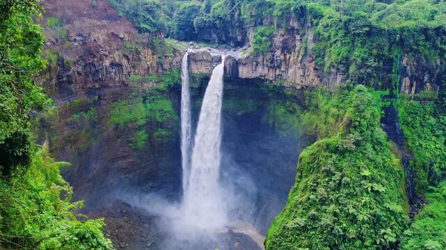 Koban Sriti Waterfall, top view, 120-meter waterfall located in Lumajang, East Java, Indonesia. A bird's-eye view of the waterfall in the jungle. Dron. 4K