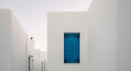 Fototapeta premium Minimalist view of white Cycladic architecture with bright blue