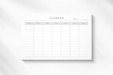 Horizontal minimal planner template photographed on a clean white background with soft shadows, neutral tones, calm organized mood, ideal for productivity concepts, business planning, time management