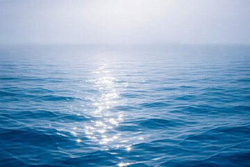 Fototapeta premium horizontal photo of calm blue ocean with sunlight reflection on water surface, clean seascape with soft ripples and open horizon, peaceful summer mood perfect for travel branding, relaxation themes