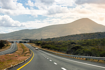 Van traveling alone on highway at sunset between Morelia and Guadalajara (Mexico)