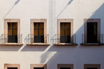 Colonial windows with shadows in historic center of Morelia, Mexico