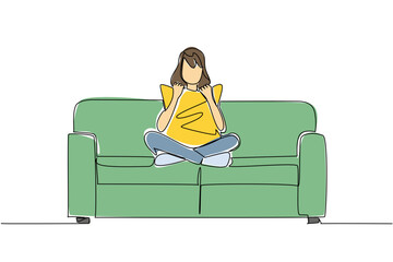 One line drawing of a woman sitting cross legged on a couch, holding and cuddling pillow to her chest, engrossed in a movie alone, symbolizing comfortable solitude and personal entertainment.