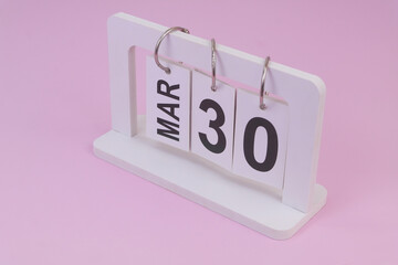 March 30 on calendar on pink background	