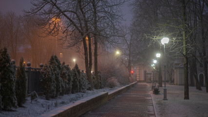 evening in a snowy winter city park.