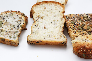 Sliced multigrain bread topped with pumpkin seeds, sunflower seeds, sesame, and black sesame.