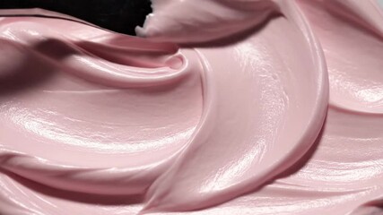 Close-up of Swirled Pink Frosting with Glossy Finish for Dessert Decoration and Baking Backgrounds Emphasizing Smooth Texture and Creamy Consistency