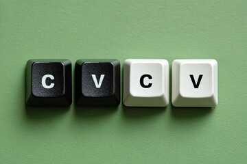 Four keys, two black and two white, with letters C and V