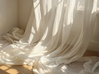 Elegant Sheer White Fabric Drapes on Wooden Floor in Sunlight