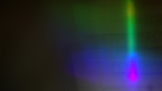 Slim neon column of green dropping into violet pool, vertical spectrum beam hovering in shadow, dreamy abstract prism light reflecting across layered waves of color

 - Powered by Adobe